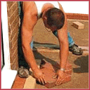Paving contractor laying 90 degree herringbone block paving laying patterns